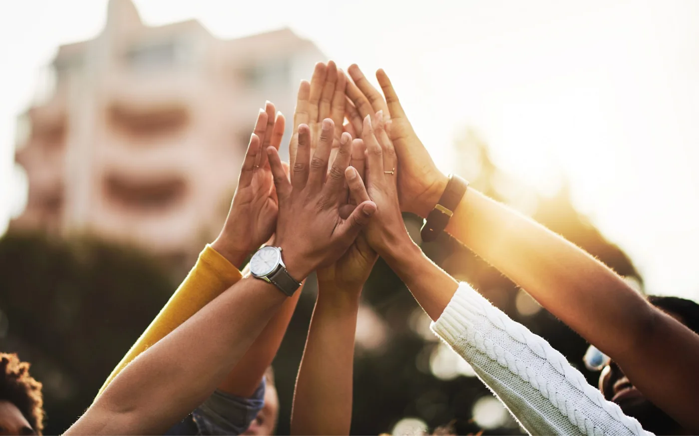 Hands joined in a gesture of cooperation alongside information about support for Citizens Network Watchdog Poland