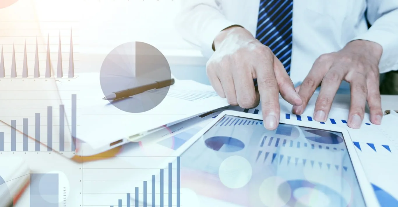 Analysts reviewing financial reports and charts during a collaborative data analysis